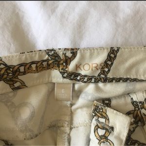 Michael Kors white jeans with gold chains all over